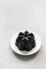 Black Matcha Cream Pudding, Panna Cotta on a plate. Copy space