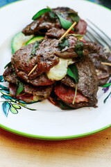 Grilled veal picatta with vegetables on the outdoor grill