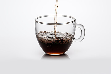 A cup of coffee being poured into a cup on a white background.