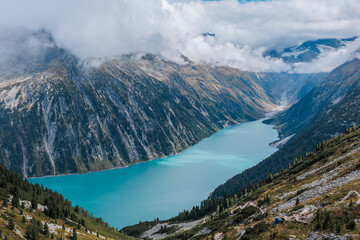 Nestled serenely amidst the rugged peaks of the majestic mountains, this pristine alpine lake...