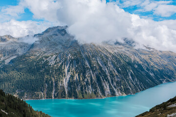 Nestled serenely amidst the rugged peaks of the majestic mountains, this pristine alpine lake...