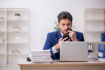 Young male employee working in the office