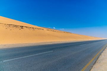 Fototapeta na wymiar A view of sand dunes beside the coast road between Walvis Bay and Swakopmund, Namibia in the dry season