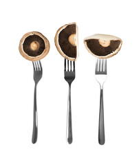 Portobello mushroom, portabella or portobella isolated on forks on white background. Big brown sliced