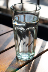 glass of water on wooden table , clean water,drinking water