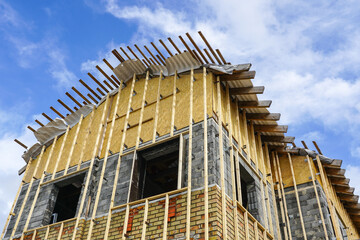 The facade of an residential house with wooden laths before applying the thermal insulation layer