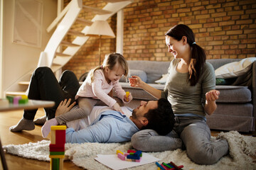 Young family playing with Bricks on the living room floor
