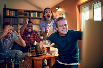 Elated friends celebrate a thrilling sports moment on TV