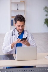 Young male doctor in telemedicine concept