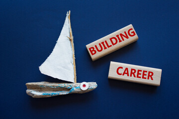 Building Career symbol. Wooden blocks with words Building Career. Beautiful deep blue background...