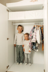 small children playing in the closet