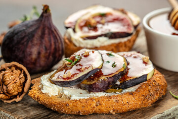 Canape, crostini or bruschetta with fresh figs, cream cheese and honey. place for text, top view