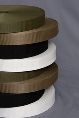 rolls of thread on factory equipment. colorful textiles in stock. cotton fiber thread production