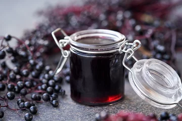 Fotobehang Black elderberry syrup in a glass jar © Madeleine Steinbach