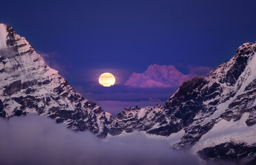 Kangchenjunga mount: Majestic Third-Highest Peak at 8586m, Full Moonrise from Mera Peak High Camp, a breathtaking moment in the Himalayas. Traveling, beauty in Nature and mountaineering concept photo.