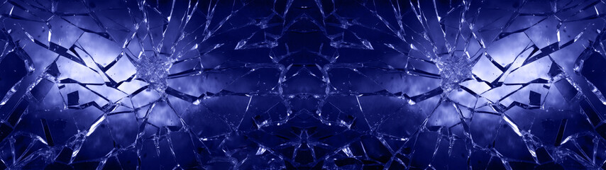 Cracked glas, shards of broken glas on blue background, abstract texture design 