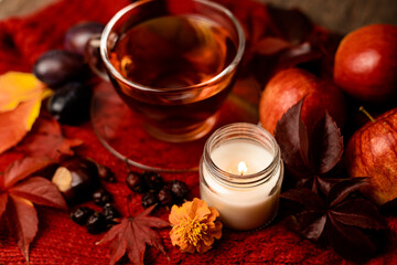 Autumn arrangement of pumpkins, apples, tea and candles
