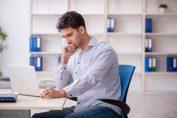 Young male employee working in the office