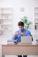 Young male employee working in the office