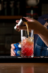 Bartender preparing a cocktail in a restaurant, close-up