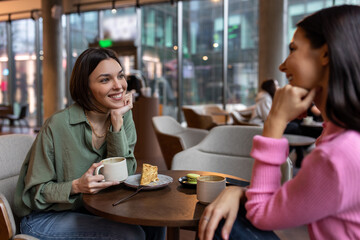 Two friends talking in a cafe and looking involved