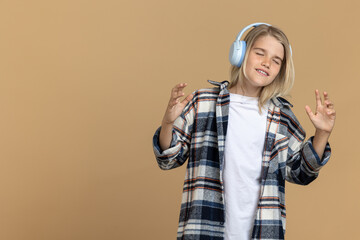Teen girl in headphones looking enjoyed while listening to music