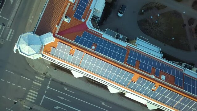 Solar photovoltaic panels mounted on roof of Swedish condo building in Linkoping residential area. Renewable electricity development