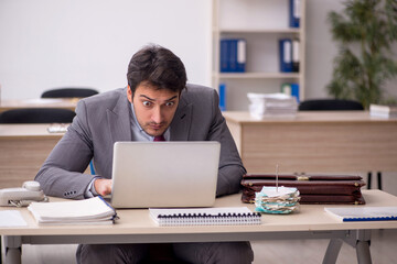 Young male employee working in the office