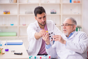 Two male chemists working at the lab