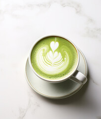 Cup of matcha latte on white marble table