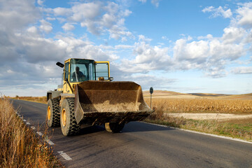 Bulldozer driving on a country road