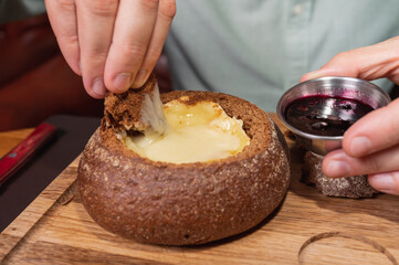 close up view, man eats reheated calumber cheese in a restaurant, cafe, close-up view