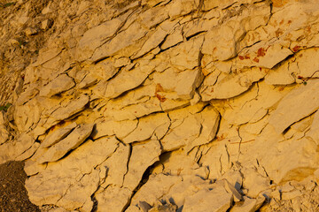 scree from the mountain on the shore stones from opoka at the golden hour, close-up texture