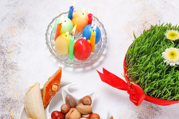 Traditional Azerbaijan holiday Novruz background with green semeni,traditional azerbaijan sweets,shekerbura,qogal,paxlava,mutaki and different nuts and sweets,top view,space for copy