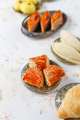 Traditional Azerbaijan holiday Novruz background with green semeni,traditional azerbaijan sweets,shekerbura,qogal,paxlava,mutaki and different nuts and sweets,top view,space for copy