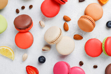 Colorful french dessert macarons with fresh fruits and nuts.