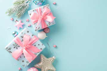 Unwrap glamour of holidays with stunning gifts and festive accents. Top view balls, sparkling star, dainty presents with silk bows, frosted fir branches on pastel blue backdrop, ideal for text or ad