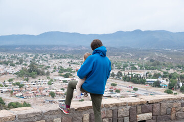 Father and baby watching outskirts of the city of Mendoza