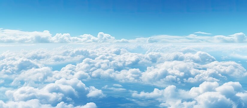 Bird S Eye View Of The Sky Seen From The Window Of An Airplane Showing Clouds And A Clear Blue Background