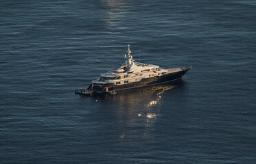 Obraz premium Monaco, lonely mega yacht in sea at sunset, huge motor boat, wealth life of billionaires 