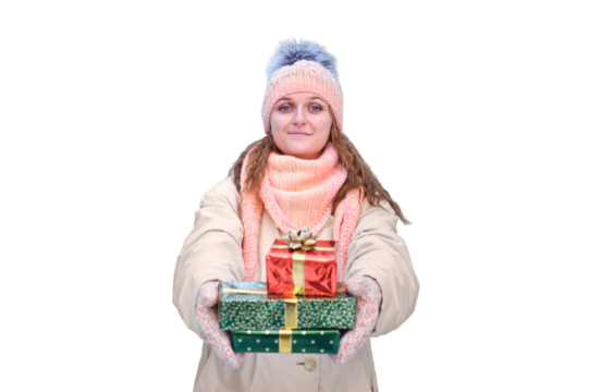 A happy woman in winter clothes stands with gifts at a in a snowy forest on New Year Eve, isolated on a white background