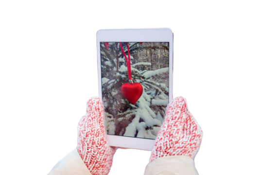 Woman takes a photo of a snow Christmas tree toy on a digital tablet camera, isolated on a white background. New Year in a winter park with snowy trees - Powered by Adobe