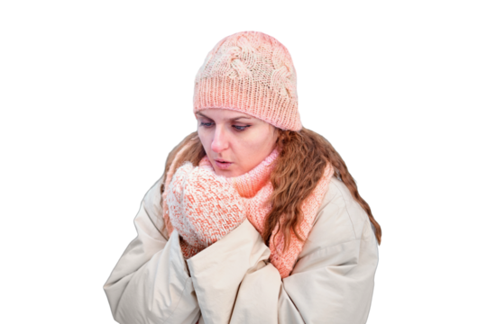An adult woman is cold and blows on her hands to keep warm, isolated on a white background