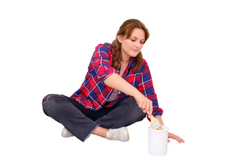 A woman dips a brush into a jar of white paint, isolated on a white background. Painting work in the repair of the apartment
