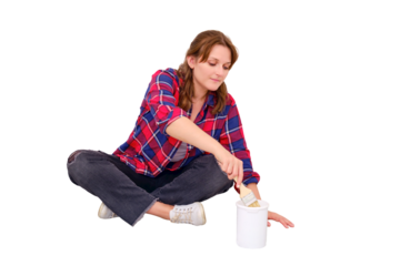 A woman dips a brush into a jar of white paint, isolated on a white background. Painting work in the repair of the apartment