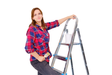 Woman painter in a plaid shirt stands on a stepladder, isolated on a white background