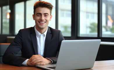 Fototapeta premium Handsome Businessman Working with Laptop Computer, Male Manager Works in Modern Office, Analysis Data Statistics and Business Planning.