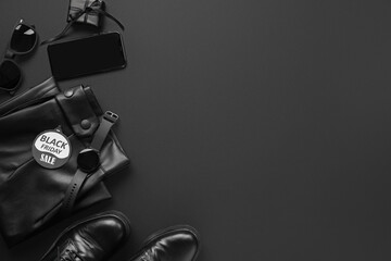 Naklejka premium Composition with gadgets, stylish female clothes and shoes on dark background. Black Friday sale