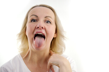 a woman shows her tongue healthy clean tongue result of cleaning the tongue. Female tongue with a...