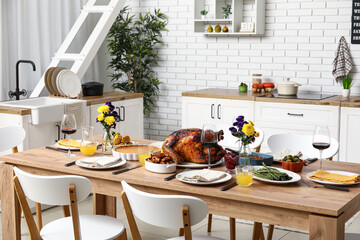 Festive dining table with tasty food for Thanksgiving Day in kitchen